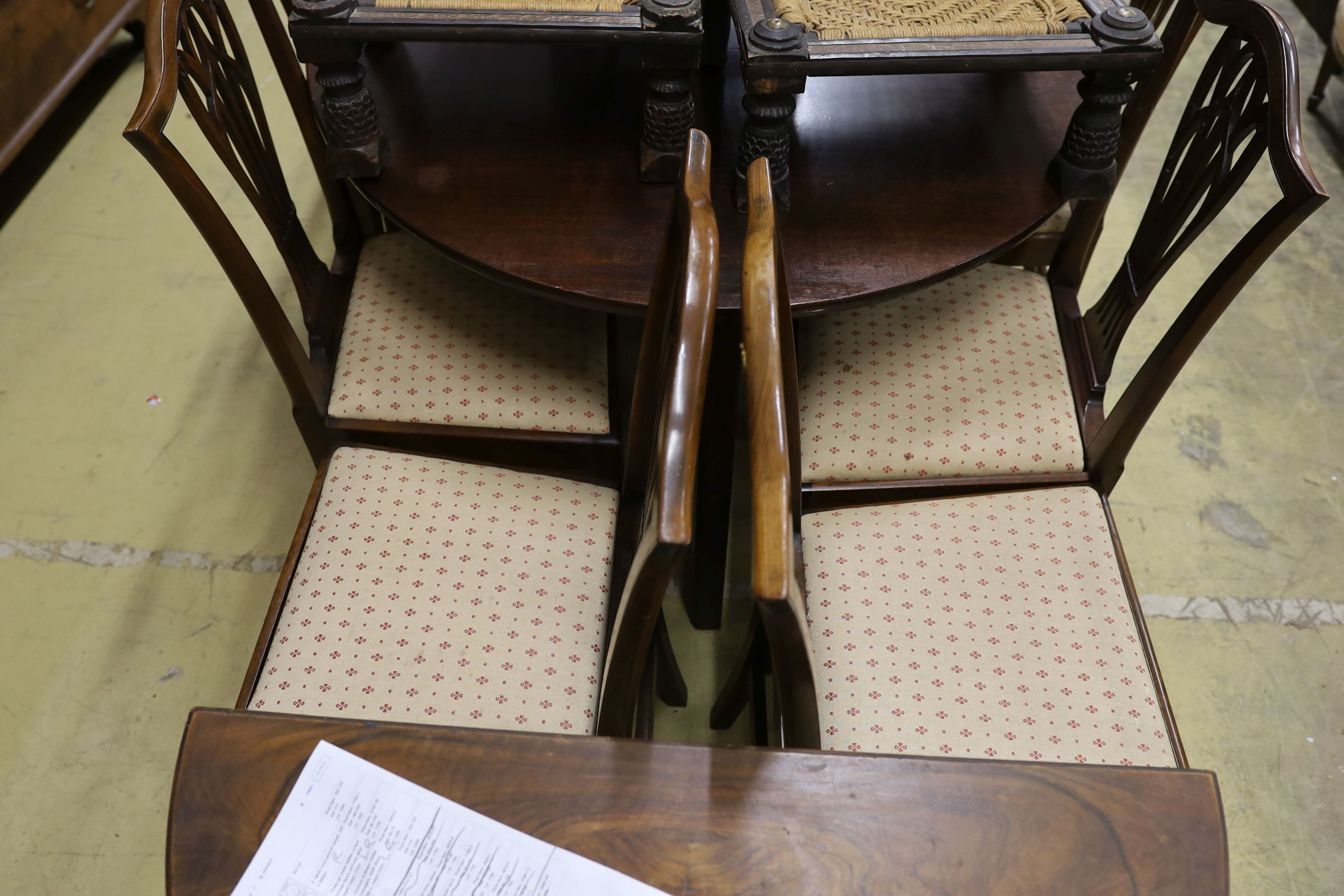 A set of nine George III and later mahogany dining chairs with pierced splats and upholstered drop in seats (six antique three reproductions, one with arms)